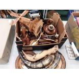 A box of wooden items to include a nutcracker, musical windmill lamp, horns, mask etc.