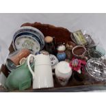 A box of various items to include decorative plates, mugs and glassware.