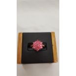 A new 9 carat rose gold pink daisy ring, size O.