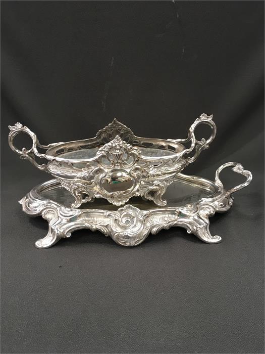 A late 19th century silver plated Art Nouveau centrepiece after W M F, resting on a mirror plateau.