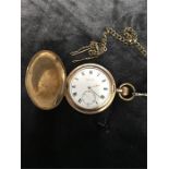 A gold plated fob watch and chain.