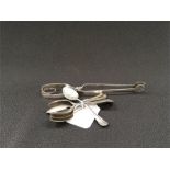 A quantity of silver teaspoons together with a set of silver tongs.