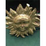 A papier-mâché gold sun.