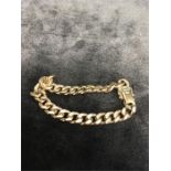 A gold link bracelet.