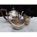 A three piece silver tea set.