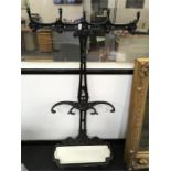 An ornate black cast iron hall stand with original drip tray.