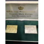 A box containing two Replica Stamps one in 22ct gold and the other in silver both weighing 26.4