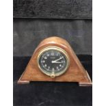 A Waltham 8 day Military flight clock. Later mounted in an oak case with black face and white