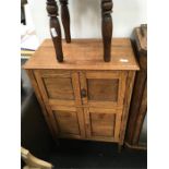 A small light oak pot cupboard.