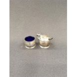 Two silver salts with blue glass linings.