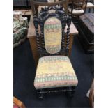 A Victorian carved back oak hall chair.