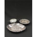 Three small silver bowls.