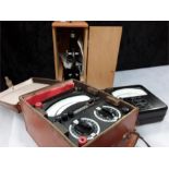 Two amp meters and a microscope, in a wood box.