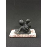 A metal figure on marble base.