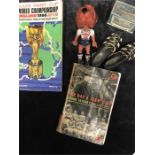 A box of football memorabilia including a vintage World Cup Willie toy.