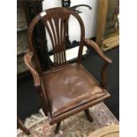 A mahogany swivel desk chair.