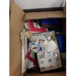 A box containing First Day Covers, commemorative stamp box, loose stamps etc.