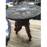 A small carved Indian hardwood table.