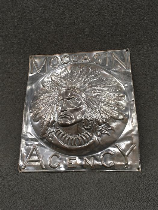 A Moccasin Agency metal plaque.