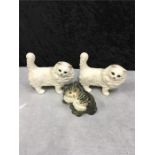 A collection of three Beswick cats.