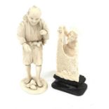 Two ivory okimono figures of a Japanese man (h. 14cm) and a fisherman casting his nets on wooden