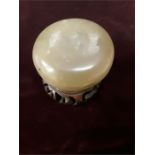 A small circular jade cosmetic box with cover yellowish translucent nephrite with black flecks