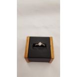 A 9 carat gold diamond solitaire ring, 0.15 points, size M.