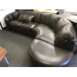 A large brown leather corner sofa.