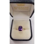 A 14 carat gold amethyst solitaire ring.