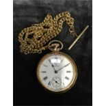 A gold coloured fob watch and chain.