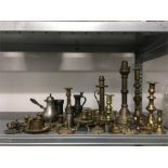 A collection of brass candlesticks and other metalware to include storm light, students lamp, patent