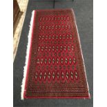 A handmade red ground Persian carpet. runner No. 232, 136 x 64 cm, Torkaman.