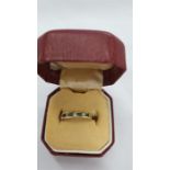 An 18 carat gold emerald and diamond ring, size L.