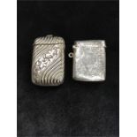 Two Vesta cases. One in engraved silver.