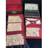 A mahjong set in a simulated leather case together with a boxed abacus.