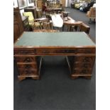 A large wooden pedestal desk with leather inlaid top.