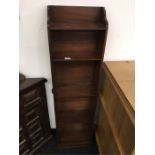 A small mahogany narrow bookcase.