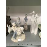 Two Lladro figures with two others.