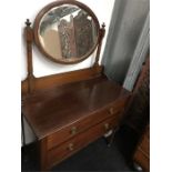 A a 1920s oak dressing chest of two drawers with mirror top.
