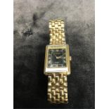 A Gents wristwatch in gold coloured case.