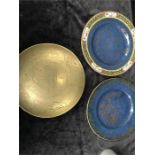 A brass bowl together with two blue glazed staffs plates in the oriental style.