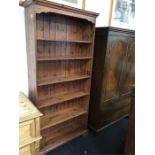 A large pine book shelving unit of six shelves.