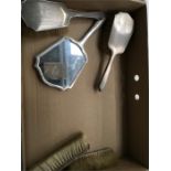 A five piece silver dressing table set.