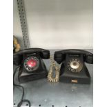Two vintage black Bakelite telephones.