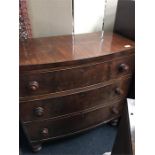 A mahogany bow fronted chest of three drawers.