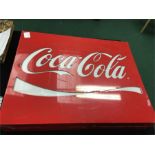 A plastic Coca Cola sign