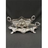 A late 19th century silver plated Art Nouveau centrepiece after W M F, resting on a mirror plateau.