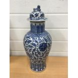 A large antique Chinese blue and white vase in the lotus leaf and chrysanthemum pattern with lid.