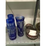 A collection of various glassware including a pair of blue flashed and acid cut vases decorated with