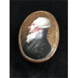 An antique enamel on copper snuff box depicting a portrait of a gentleman. Examine.